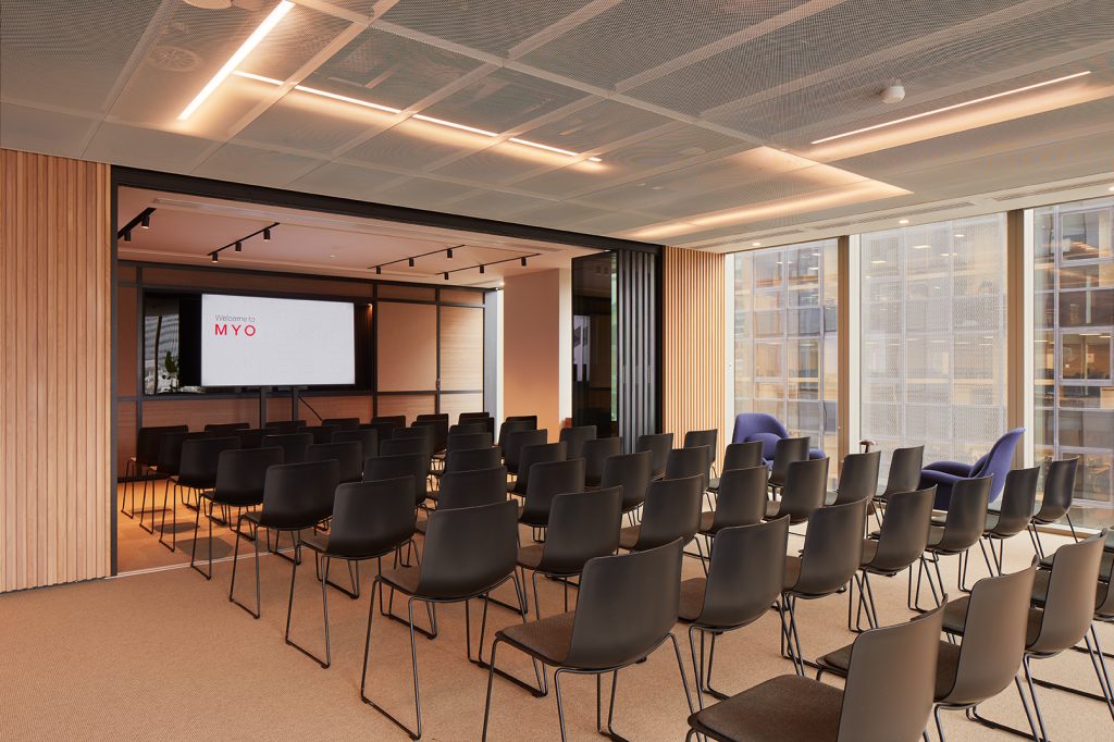 A presentation room filled with chairs and a projection screen at Myo's Liverpool Street offices.