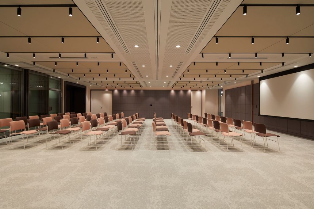 Myo St. Pauls conference area in a conference style layout in front of a large projector screen.