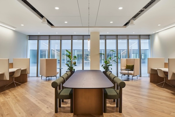 A bright and airy meeting space with side desks.