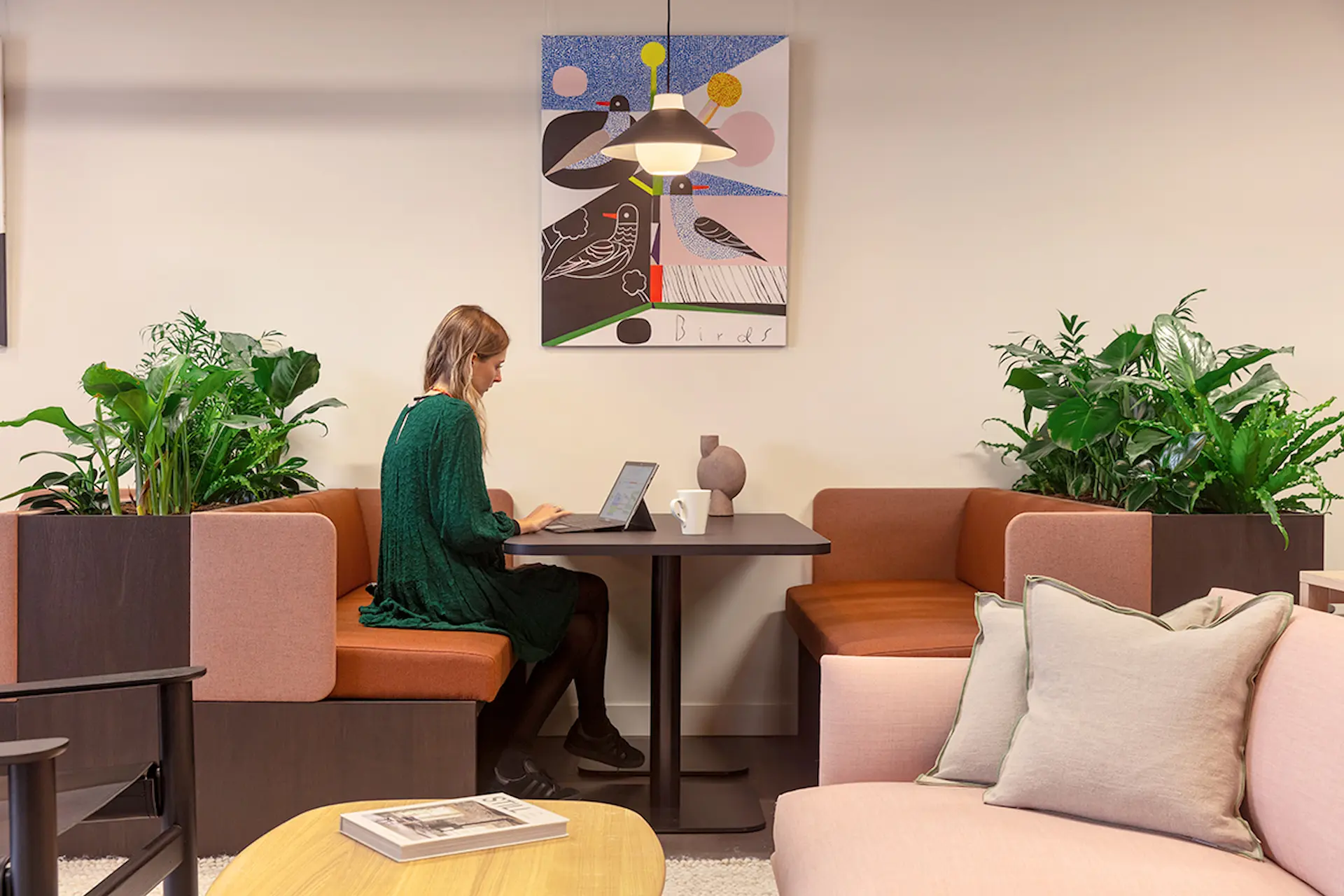 An employee working at her laptop in a quiet space.